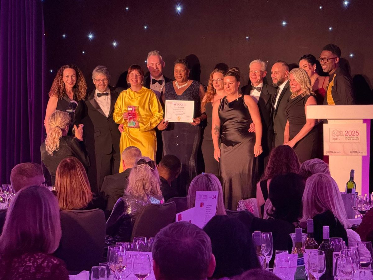 Group of men and women receiving an award at the HPMA awards